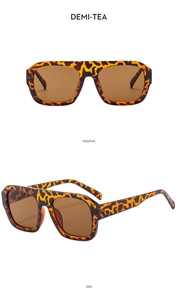 Detail of tortoise shell aviator sunglasses with flat top frame and demi-tea lenses