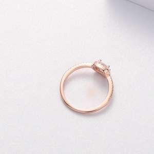 Detail macro view of a rose gold square-cut zircon ring with small side diamonds
