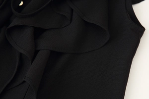Detailed close-up of layered ruffle texture on a black chiffon two-piece skirt set