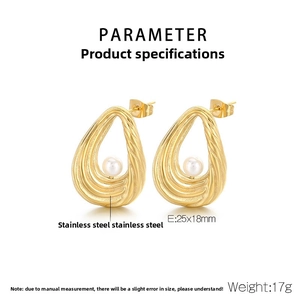 Macro shot of gold-plated striped textured oval earrings with white pearl inlay detail