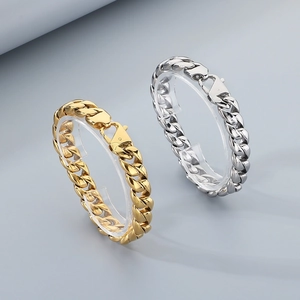 Close-up of 12mm polished Cuban link bracelets in gold and silver steel finishes