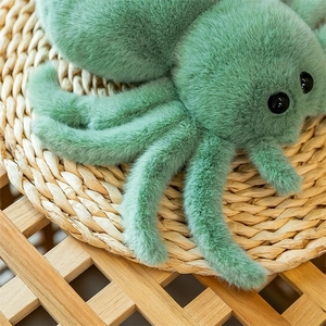 Detailed view of the soft green plush spider toy with realistic black plastic eyes