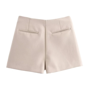 Detailed view of high waisted beige culottes with sharp tailoring and side pockets