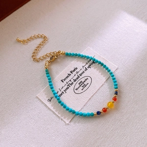 Detail of turquoise beaded bracelet with silver accents and golden adjustable chain link