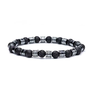 Macro shot of 8mm black lava stone beads with silver-tone cylindrical metal spacers