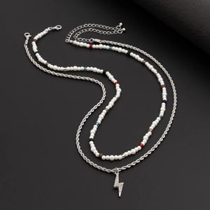 Double-layer beaded necklace with lightning pendant and pearls on black background