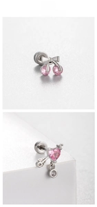 Detail view of pink cherry and heart arrow stud earrings in polished silver titanium steel