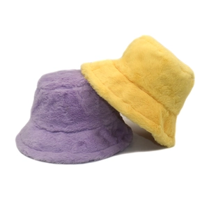Solid color faux rabbit fur bucket hats in purple and yellow for winter warmth
