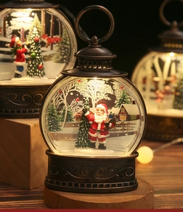 Detail of vintage bronze Christmas lantern featuring Santa Claus and warm glowing LED light