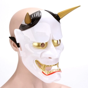 Detailed side view of a white Japanese Hannya mask with gold horns and black elastic strap
