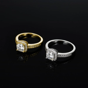 Macro shot of gold and silver square cut moissanite rings with pavé diamonds on black background