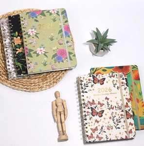 Detail of 2026 weekly planner with floral cover, spiral binding and elastic closure