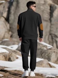 Men's black knit sports suit featuring distinctive brown suede elbow patches on the back