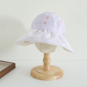 Detail of lavender floral child sun hat with white ruffled brim and bow pattern