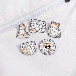 Set of five cute cartoon cat enamel pins on canvas bag with fun English typography