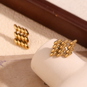 Macro detail of gold-plated geometric woven texture stud earrings for women
