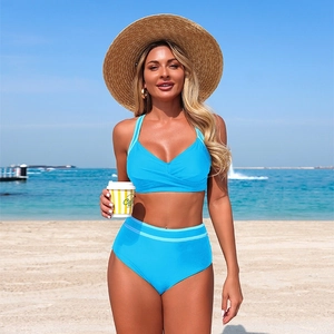 Bright blue high waisted two-piece bikini swimsuit with cross-wrap top and striped waistband