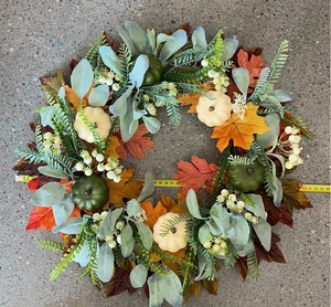Detailed view of fall wreath with maple leaves and pumpkins measuring 50cm in diameter