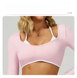 Close-up of pink long-sleeved yoga top with contrast piping and layered design detail