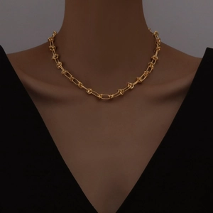 18K gold minimalist thorn knot chain necklace worn by a model for a hip hop chic look