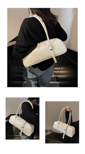 Detailed views of a white minimalist baguette bag with adjustable strap and silver buckle