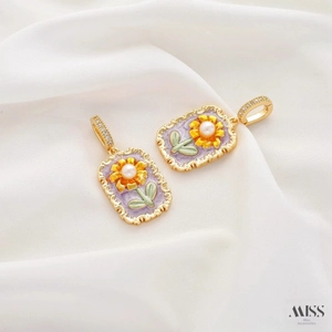 Macro shot of French vintage lavender enamel earrings with sunflower and pearl details