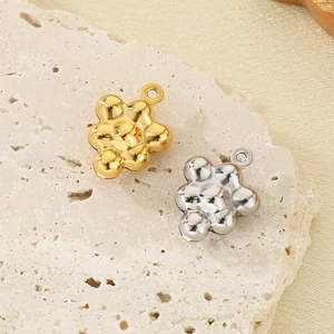 Detailed view of cloud-shaped hollow metal pendants in gold and silver finish