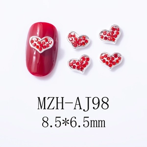 Detailed view of red heart nail charms with silver frame, size 8.5x6.5mm for manicure