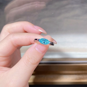 925 sterling silver ring with marquise-cut lake blue moissanite gemstone shown on finger