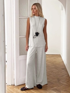 Women's grey two-piece lounge set with high-neck sleeveless top and wide-leg knit trousers