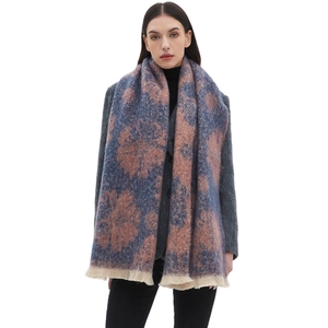 Blue and pink floral jacquard scarf with soft tassels shown on a model on white background