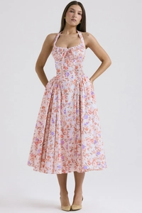Close-up of floral halter neck dress featuring corset waist and flowing chiffon skirt