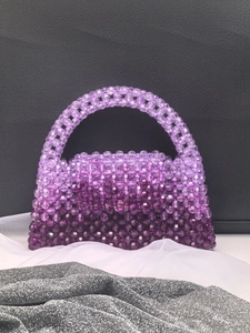 Detailed close-up of handmade purple gradient beaded handbag with transparent beads