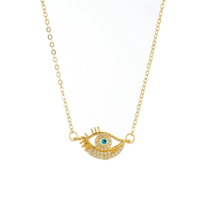 Detail of gold evil eye pendant featuring blue shell center and sparkling zircon crystals