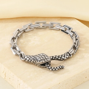 Detail of snake head clasp with scale texture on a punk style stainless steel chain