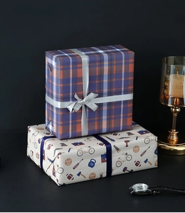Macro shot of plaid and icon gift wrapping paper with premium satin ribbon detail
