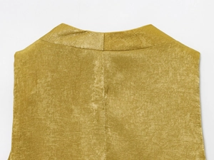 Dettaglio della cucitura del colletto posteriore e texture satinata dorata sulla camicia