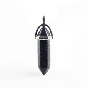 Macro view of a hexagonal obsidian stone pendant with a polished silver metal clasp