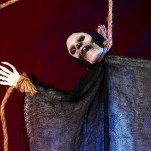 Close-up of a hanging ghost skeleton with red glowing eyes and black gauze robe