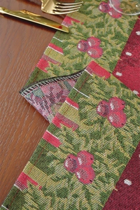 Close-up of festive jacquard weave texture with snowman and floral holiday patterns