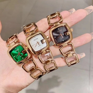 Detailed view of three square quartz watches with gold hollow bracelet straps in three colors