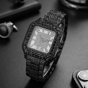 Detail of a square hip hop watch with black crystals, roman numerals, and date window