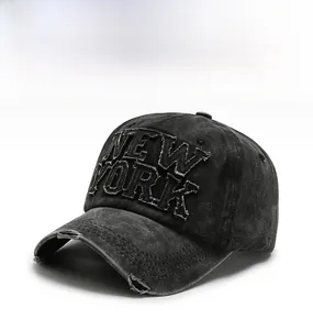 Detail of distressed black washed denim baseball cap with New York 3D embroidery