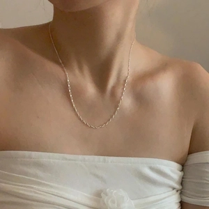 Close-up of minimalist S925 sterling silver pig nose link necklace worn on model neck