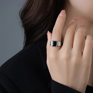Watch band style adjustable silver ring with a large square black zircon on female hand