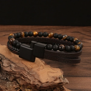 Detail view of multi-layer leather bracelet with tiger eye beads and black magnetic clasp