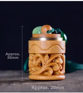 Macro shot of hand-carved sandalwood sachet pendant showing 30mm height detail