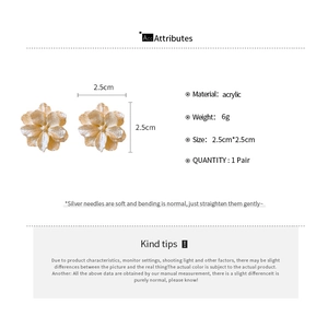 Detailed view of champagne gold camellia flower earrings with silver needle specs