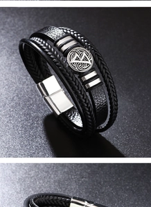 Détail macro du bracelet multicouche en cuir noir avec breloque nœud argenté et fermoir magnétique