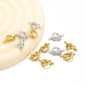 Detailed view of gold and silver heart-shaped knot connectors for DIY jewelry making